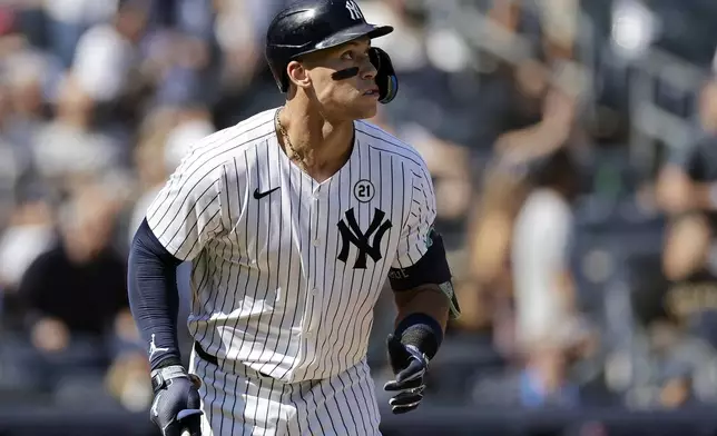 New York Yankees' Aaron Judge watches his two-run home run during the third inning of a baseball game against the Boston Red Sox, Sunday, Sept. 15, 2024, in New York. (AP Photo/Adam Hunger)