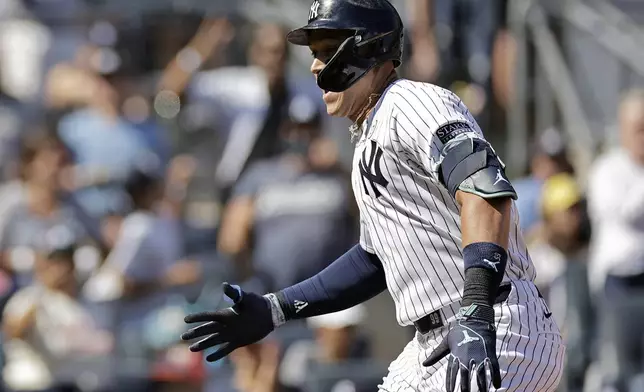 New York Yankees' Aaron Judge reacts after hitting a two-run home run during the third inning of a baseball game against the Boston Red Sox, Sunday, Sept. 15, 2024, in New York. (AP Photo/Adam Hunger)