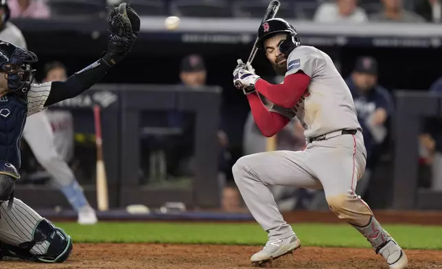 Boston Red Sox's Connor Wong, right, ducks as he is almost hit by a pitch during the ninth inning of a baseball game against the New York Yankees at Yankee Stadium, Thursday, Sept. 12, 2024, in New York. (AP Photo/Seth Wenig)