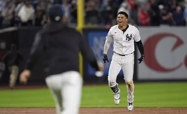 New York Yankees' Juan Soto, right, reacts after hitting the winning base hit during the 10th inning of a baseball game against the Boston Red Sox at Yankee Stadium, Thursday, Sept. 12, 2024, in New York. (AP Photo/Seth Wenig)