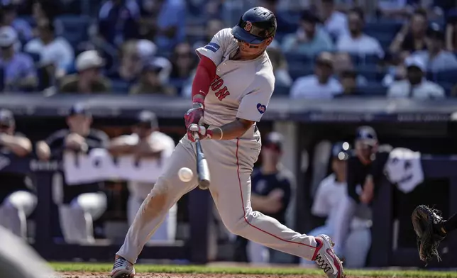 Boston Red Sox's Rafael Devers hits a two-run single during the fifth inning of a baseball game against the New York Yankees, Saturday, Sept. 14, 2024, in New York. (AP Photo/Frank Franklin II)