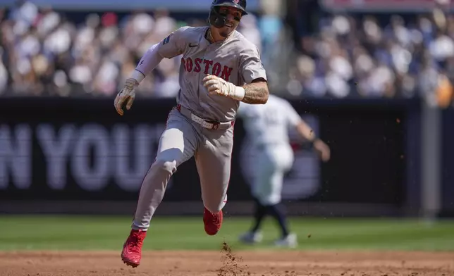 Boston Red Sox's Jarren Duran runs to third base on a two-run single by Rafael Devers during the fifth inning of a baseball game against the New York Yankees, Saturday, Sept. 14, 2024, in New York. (AP Photo/Frank Franklin II)