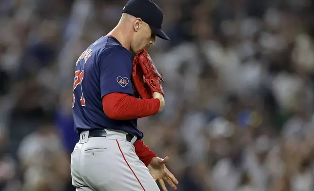 Boston Red Sox relief pitcher Cam Booser reacts after giving up a grand slam to New York Yankees' Aaron Judge during the seventh inning of a baseball game Friday, Sept. 13, 2024, in New York. (AP Photo/Adam Hunger)