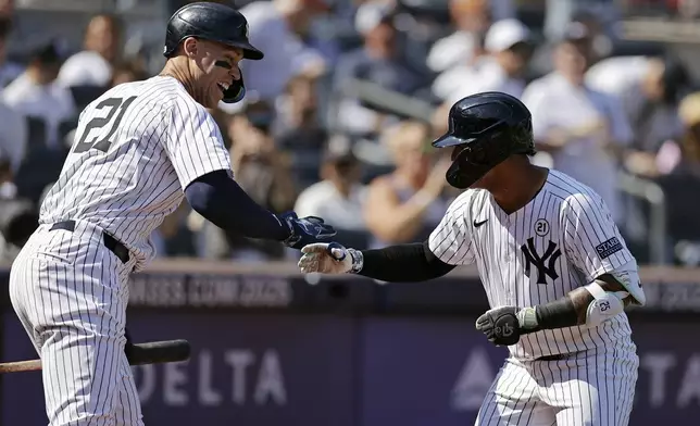 New York Yankees' Gleyber Torres, right, is congratulated by Aaron Judge, left, after hitting a home run during the third inning of a baseball game against the Boston Red Sox, Sunday, Sept. 15, 2024, in New York. (AP Photo/Adam Hunger)