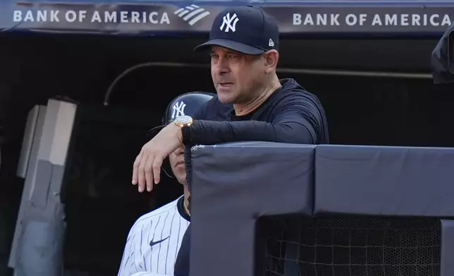 New York Yankees manager Aaron Boone watches from the dugout steps during the ninth inning of a baseball game against the Boston Red Sox, Saturday, Sept. 14, 2024, in New York. The Red Sox won 7-1. (AP Photo/Frank Franklin II)