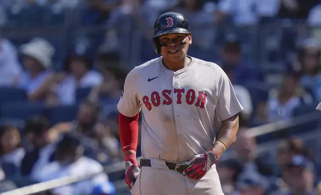 Boston Red Sox's Rafael Devers smiles after hitting a two-run single during the fifth inning of a baseball game against the New York Yankees, Saturday, Sept. 14, 2024, in New York. (AP Photo/Frank Franklin II)