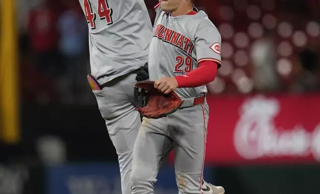 Cincinnati Reds' Elly De La Cruz (44) and TJ Friedl (29) celebrate a 3-0 victory over the St. Louis Cardinals following a baseball game Tuesday, Sept. 10, 2024, in St. Louis. (AP Photo/Jeff Roberson)