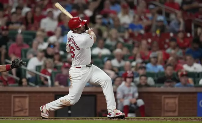 St. Louis Cardinals' Paul Goldschmidt follows through on an RBI double during the eighth inning of a baseball game against the Cincinnati Reds Wednesday, Sept. 11, 2024, in St. Louis. (AP Photo/Jeff Roberson)