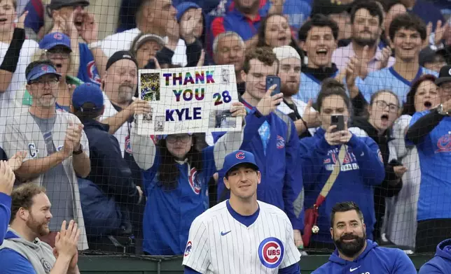 Chicago Cubs starting pitcher Kyle Hendricks steps out of the dugout for a curtain call after being pulled in the eighth inning of a baseball game against the Cincinnati Reds on Saturday, Sept. 28, 2024, in Chicago. (AP Photo/Charles Rex Arbogast)