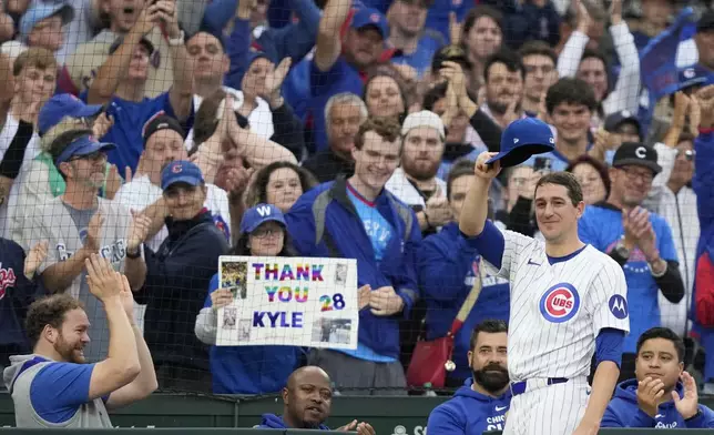 Chicago Cubs starting pitcher Kyle Hendricks tips his cap to the Wrigley Field fans after being pulled in the eighth inning of a baseball game against the Cincinnati Reds on Saturday, Sept. 28, 2024, in Chicago. (AP Photo/Charles Rex Arbogast)