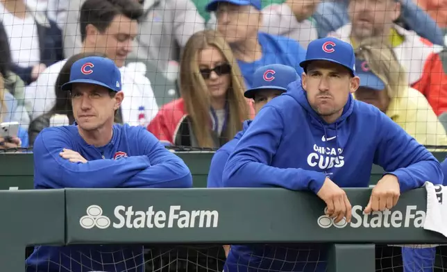 Chicago Cubs manager Craig Counsell, left, and bench coach Ryan Flaherty look out over the field during the third inning of a baseball game against the Cincinnati Reds on Saturday, Sept. 28, 2024, in Chicago. (AP Photo/Charles Rex Arbogast)