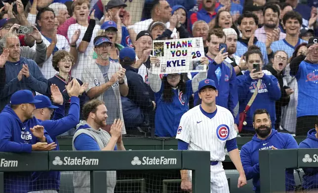 Chicago Cubs starting pitcher Kyle Hendricks steps out of the dugout for a curtain call after being pulled in the eighth inning of a baseball game against the Cincinnati Reds on Saturday, Sept. 28, 2024, in Chicago. (AP Photo/Charles Rex Arbogast)