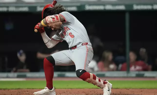 Cincinnati Reds' Jonathan India falls after being hit with a pitch in the fifth inning of a baseball game against the Cleveland Guardians in Cleveland, Tuesday, Sept. 24, 2024. (AP Photo/Sue Ogrocki)