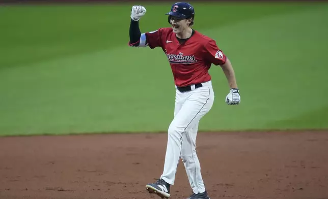 Cleveland Guardians' Kyle Manzardo celebrates as he runs the bases with a home run in the first inning of a baseball game against the Cincinnati Reds in Cleveland, Tuesday, Sept. 24, 2024. (AP Photo/Sue Ogrocki)