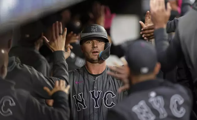 New York Mets' Pete Alonso celebrates with teammates after scoring a run during the sixth inning of a baseball game against the Cincinnati Reds, Saturday, Sept. 7, 2024, in New York. (AP Photo/Adam Hunger)