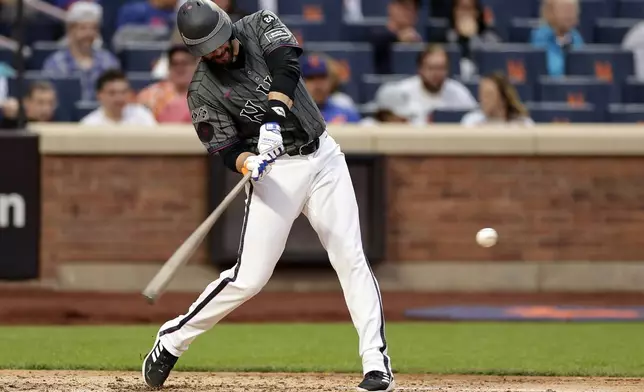 New York Mets designated hitter J.D. Martinez hits a two-run double during the sixth inning of a baseball game against the Cincinnati Reds Saturday, Sept. 7, 2024, in New York. (AP Photo/Adam Hunger)