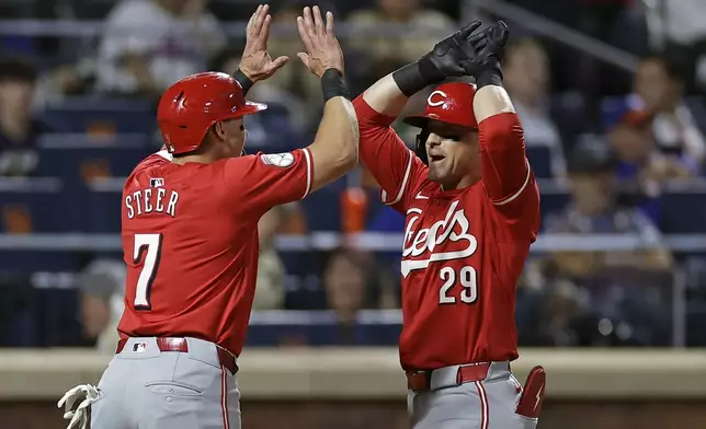 Cincinnati Reds' TJ Friedl reacts with Spencer Steer (7) after hitting a two-run home run during the seventh inning of a baseball game against the New York Mets Friday, Sept. 6, 2024, in New York. (AP Photo/Adam Hunger)