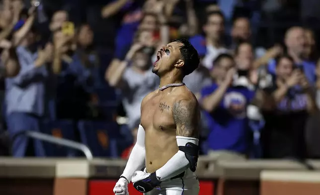 New York Mets' Mark Vientos reacts after hitting a two-run walkoff home run during the 10th inning of a baseball game against the Cincinnati Reds, Friday, Sept. 6, 2024, in New York. (AP Photo/Adam Hunger)