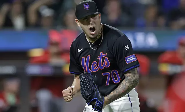 New York Mets pitcher Jose Butto reacts during the 10th inning of a baseball game against the Cincinnati Reds, Friday, Sept. 6, 2024, in New York. The Mets won 6-4. (AP Photo/Adam Hunger)