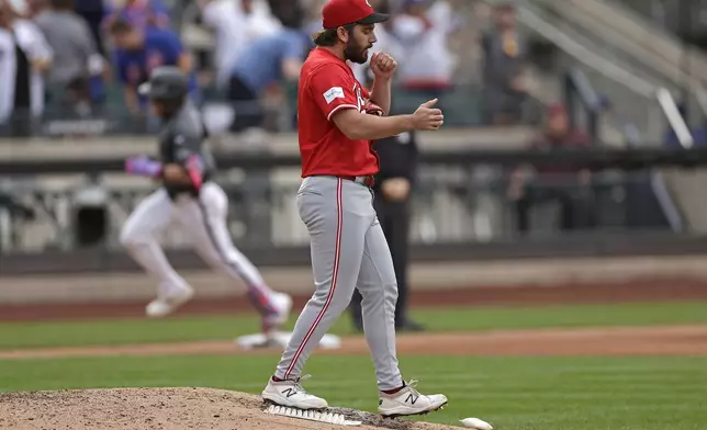 Cincinnati Reds pitcher Sam Moll reacts after giving up a home run to New York Mets' Harrison Bader during the sixth inning of a baseball game Saturday, Sept. 7, 2024, in New York. (AP Photo/Adam Hunger)