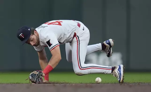 Minnesota Twins second baseman Edouard Julien fields a ball hit by Cincinnati Reds' Ty France to force a double play during the second inning of a baseball game, Saturday, Sept. 14, 2024, in Minneapolis. (AP Photo/Abbie Parr)