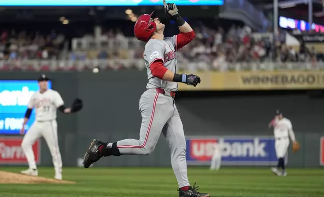 Cincinnati Reds' TJ Friedl points while running the bases after hitting a 2-run home run during the fourth inning of a baseball game against the Minnesota Twins, Saturday, Sept. 14, 2024, in Minneapolis. (AP Photo/Abbie Parr)