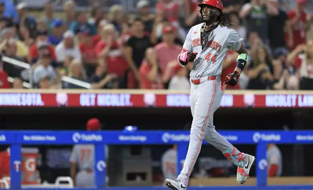 Cincinnati Reds Elly De La Cruz runs home after hitting a grand slam during the seventh inning of a baseball game against the Minnesota Twins, Friday, Sept. 13, 2024, in Minneapolis. (AP Photo/Nikolas Liepins)