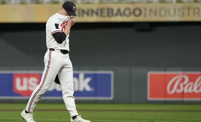 Minnesota Twins relief pitcher Louie Varland walks back to the dugout after the bottom of the fourth inning of a baseball game against the Cincinnati Reds, Saturday, Sept. 14, 2024, in Minneapolis. (AP Photo/Abbie Parr)