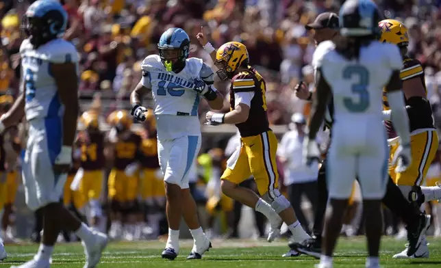 Minnesota quarterback Max Brosmer (16), center, celebrates after throwing a 29-yard touchdown pass to wide receiver Le'Meke Brockington during the second half of an NCAA college football game against Rhode Island, Saturday, Sept. 7, 2024, in Minneapolis. (AP Photo/Abbie Parr)