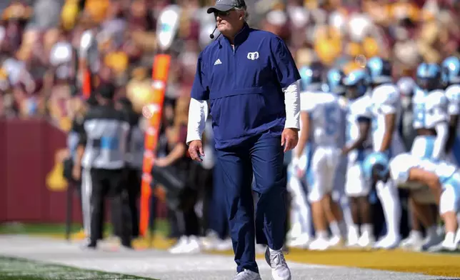 Rhode Island head coach Jim Fleming stands on the sideline during the first half of an NCAA college football game against Minnesota, Saturday, Sept. 7, 2024, in Minneapolis. (AP Photo/Abbie Parr)