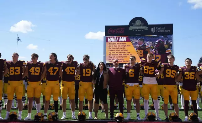 Minnesota head coach P. J. Fleck, middle, right, stands with his team after the 48-0 win against Rhode Island of an NCAA college football game Saturday, Sept. 7, 2024, in Minneapolis. (AP Photo/Abbie Parr)