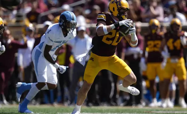 Minnesota defensive back Jack Henderson (20) runs with the football after intercepting a pass to score a pick-6 during the second half of an NCAA college football game against Rhode Island, Saturday, Sept. 7, 2024, in Minneapolis. (AP Photo/Abbie Parr)