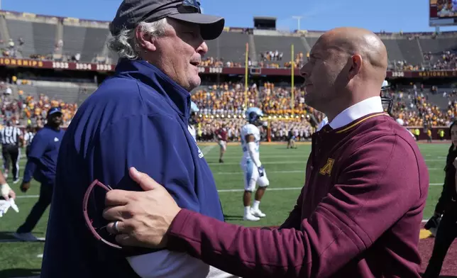 Rhode Island head coach Jim Fleming, left, and Minnesota head coach P. J. Fleck shake hands after an NCAA college football game Saturday, Sept. 7, 2024, in Minneapolis. Minnesota won 48-0. (AP Photo/Abbie Parr)