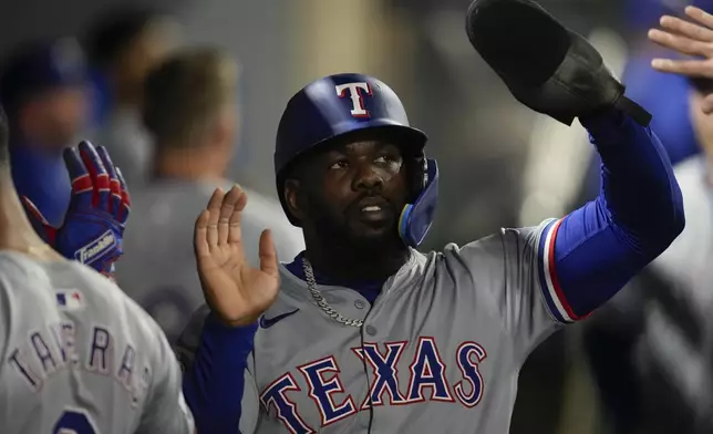 Texas Rangers' Adolis García celebrates after scoring during the fourth inning of a baseball game against the Los Angeles Angels in Anaheim, Calif., Saturday, Sept. 28, 2024. (AP Photo/Ashley Landis)