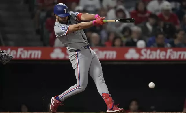 Texas Rangers' Jonathan Ornelas singles during the ninth inning of a baseball game against the Texas Rangers in Anaheim, Calif., Saturday, Sept. 28, 2024. Wyatt Langford, Matt Duffy, and Nathaniel Lowe scored. (AP Photo/Ashley Landis)