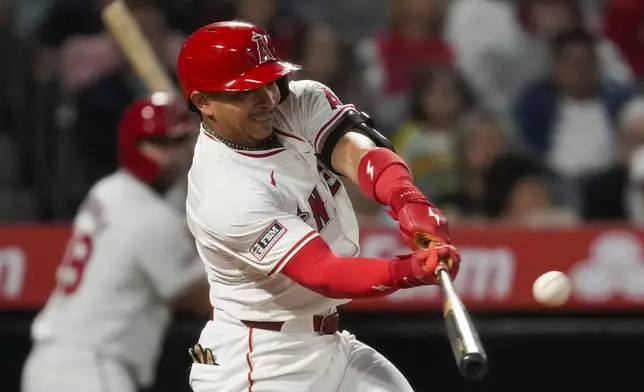 Los Angeles Angels' Gustavo Campero hits a home run during the third inning of a baseball game against the Texas Rangers in Anaheim, Calif., Saturday, Sept. 28, 2024. Brandon Drury and Logan O'Hoppe also scored. (AP Photo/Ashley Landis)