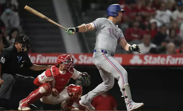 Texas Rangers' Nathaniel Lowe doubles during the eighth inning of a baseball game against the Los Angeles Angels in Anaheim, Calif., Saturday, Sept. 28, 2024. Matt Duffy scored. (AP Photo/Ashley Landis)