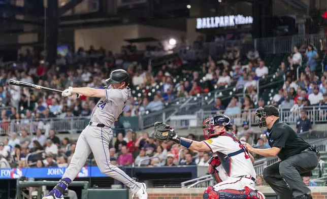 Colorado Rockies' Ryan McMahon (24) hits a single to center in the fourth inning of a baseball game against the Atlanta Braves, Thursday, Sept. 5, 2024, in Atlanta. (AP Photo/Jason Allen)