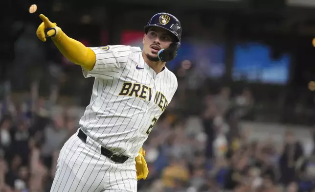 Milwaukee Brewers' Willy Adames (27) celebrates hitting a home run during the first inning of a baseball game against the Colorado Rockies, Saturday, Sept. 7, 2024, in Milwaukee. (AP Photo/Kayla Wolf)