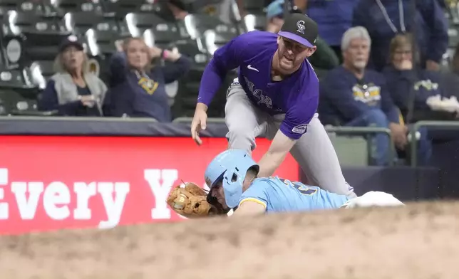 Colorado Rockies third baseman Ryan McMahon (24) tags out pinch-runner Brewer Hicklen for the final out of a baseball game Friday, Sept. 6, 2024, in Milwaukee. The Colorado Rockies won 3-2 over the Milwaukee Brewers. (AP Photo/Kayla Wolf)