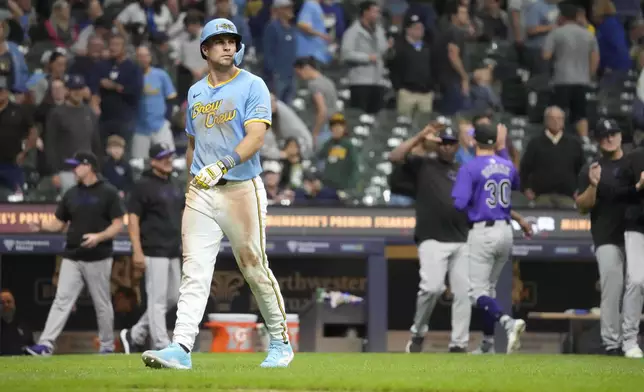 Milwaukee Brewers pinch-runner Brewer Hicklen walks off the field after getting tagged out at third base by Colorado Rockies Ryan McMahon for the final out of a baseball game Friday, Sept. 6, 2024, in Milwaukee. (AP Photo/Kayla Wolf)