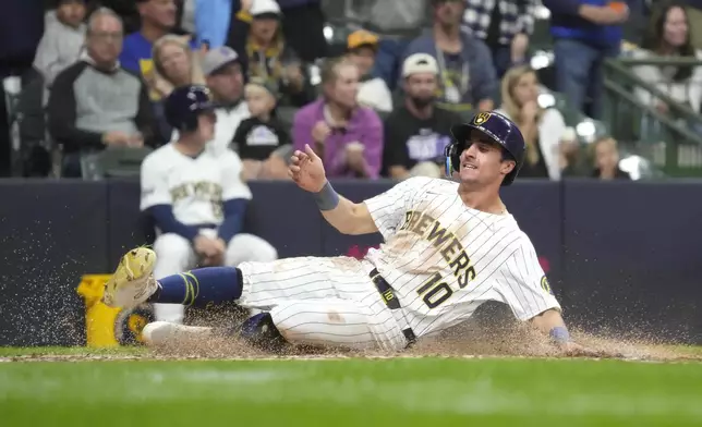 Milwaukee Brewers' Sal Frelick (10) scores on an RBI double hit by Joey Ortiz during the fourth inning of a baseball game against the Colorado Rockies, Saturday, Sept. 7, 2024, in Milwaukee. (AP Photo/Kayla Wolf)