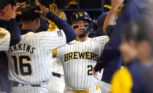 Milwaukee Brewers' William Contreras (24) celebrates in the dugout after hitting a two-run home run during the third inning of a baseball game against the Colorado Rockies Saturday, Sept. 7, 2024, in Milwaukee. (AP Photo/Kayla Wolf)