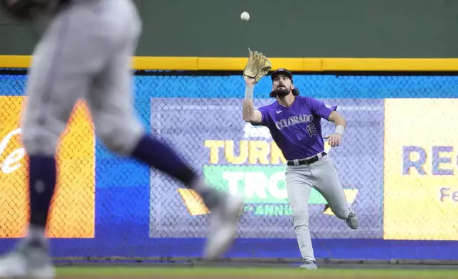 Colorado Rockies left fielder Sam Hilliard (16) catches a fly ball hit by Milwaukee Brewers' Jake Bauers during the fourth inning of a baseball game Friday, Sept. 6, 2024, in Milwaukee. (AP Photo/Kayla Wolf)