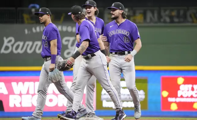 Colorado Rockies players from left; shortstop Ezequiel Tovar (14), outfielder Jordan Beck (27), first baseman Michael Toglia (4) and outfielder Sam Hilliard (16) react to winning against the Milwaukee Brewers Friday, Sept. 6, 2024, in Milwaukee. (AP Photo/Kayla Wolf)