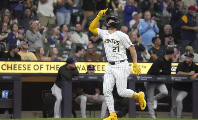 Milwaukee Brewers' Willy Adames (27) celebrates hitting a home run during the first inning of a baseball game against the Colorado Rockies, Saturday, Sept. 7, 2024, in Milwaukee. (AP Photo/Kayla Wolf)