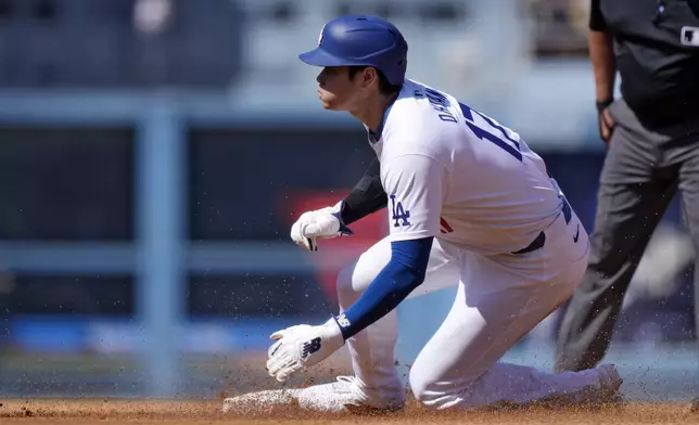 Los Angeles Dodgers' Shohei Ohtani steals second during the third inning of a baseball game against the Colorado Rockies, Sunday, Sept. 22, 2024, in Los Angeles. (AP Photo/Mark J. Terrill)