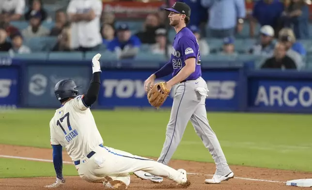 Los Angeles Dodgers designated hitter Shohei Ohtani (17) reaches third as Teoscar Hernández lines out during the ninth inning of a baseball game against the Colorado Rockies in Los Angeles, Saturday, Sept. 21, 2024. (AP Photo/Ashley Landis)