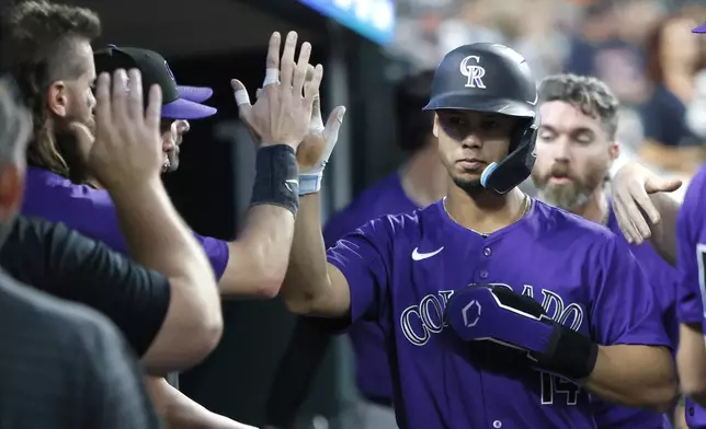 Colorado Rockies' Ezequiel Tovar celebrates after scoring against the Detroit Tigers during the fifth inning of a baseball game, Wednesday, Sept. 11, 2024, in Detroit. Tovar also drove in two runs in the fifth inning. (AP Photo/Duane Burleson)