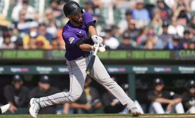 Colorado Rockies' Jacob Stallings hits a one-run double against the Detroit Tigers in the ninth inning of a baseball game, Thursday, Sept. 12, 2024, in Detroit. (AP Photo/Paul Sancya)